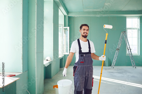 Bearded painter construction worker on a construction site.