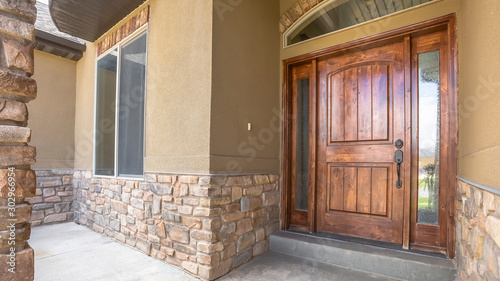Panorama frame Home porch and brown wood front door with sidelights and arched transom window