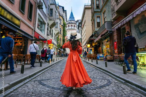 Woman standing at Galata tower in Istanbul, Turkey.