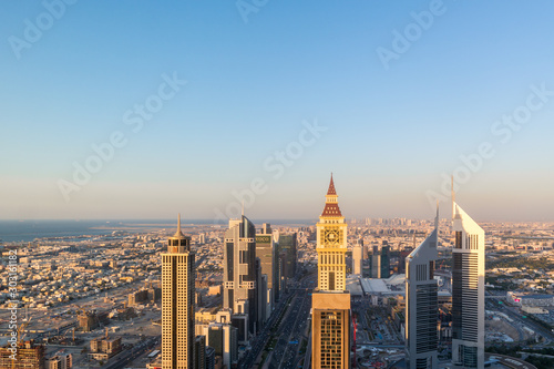 Aerial view of the iconic Sheikh Zayed road Skyscrapers and landmarks - Aerial view of Dubai city roads and Towers at sunset - Gevora Hotel view
