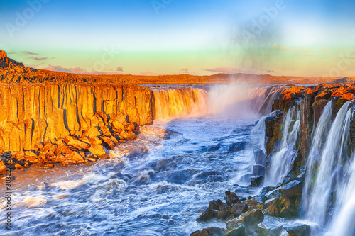 Dramatic sunset view of fantastic waterfall and cascades of Selfoss waterfall.