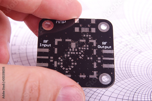 RF engineer holding empty black PCB board