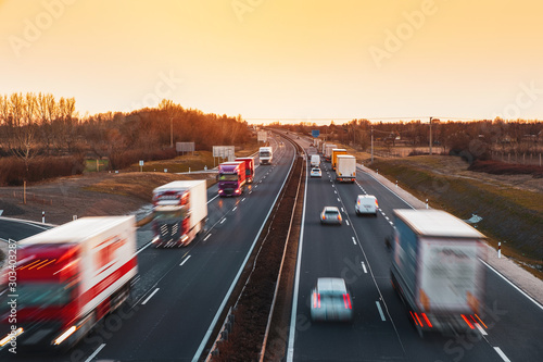 Busy highway with fast moving vehicles in beautiful sunset