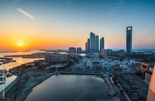 Sunset over Abu Dhabi skyline and the downtown modern buildings view