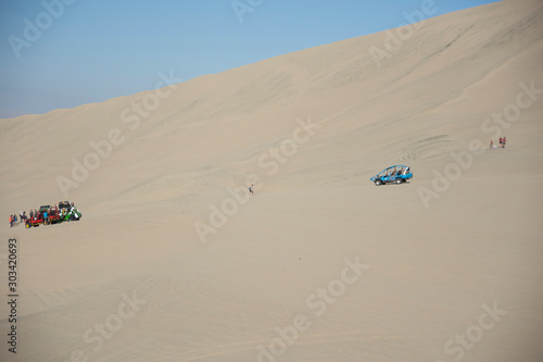 Tubular vehicle riding the dunes in Huacachina, ica desert, Peru