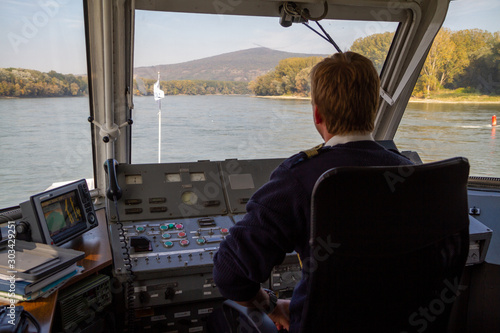 Bratislava, Slovakia. 2019/10/13. A helmsman pilots a ship on the river Danube.
