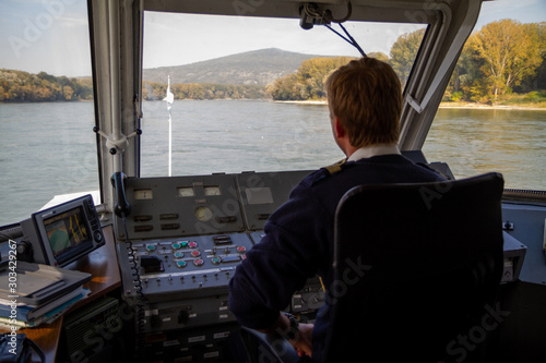Bratislava, Slovakia. 2019/10/13. A helmsman pilots a ship on the river Danube.