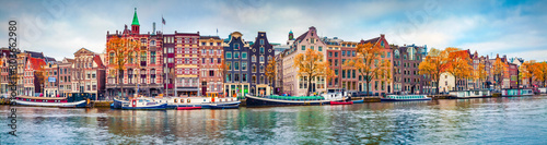 Panoramic autumn view of Amsterdam city. Famous Dutch channels and great cityscape. Colorful morning scene of Netherlands, Europe. Traveling concept background.