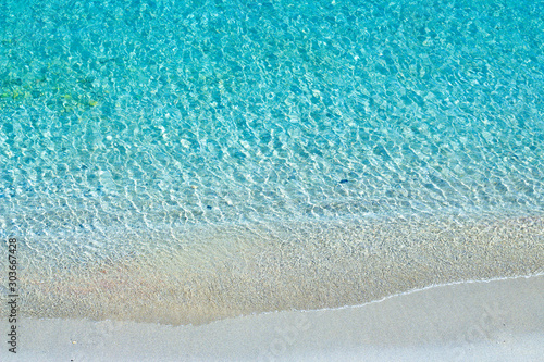 Turquoise sea waves and white sand beach, Mediterranean sea. Aerial view.