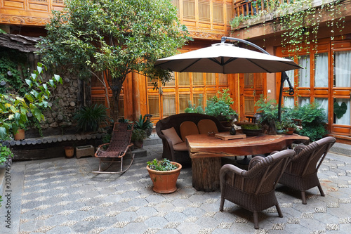 Beautiful Naxi style courtyard at Lijaing with a rattan made rocking chair, China. 