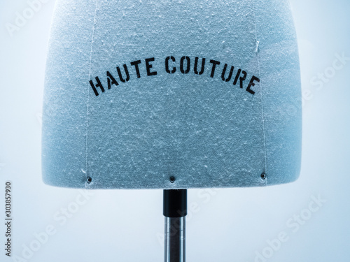 Haute Couture signage on mannequin made from fine luxury garment textile in luxury fashion store atelier