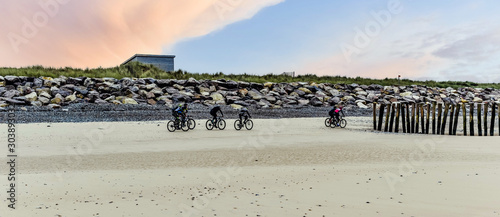 group of mountain bikes rolling on the beach