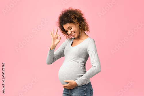 Easy pregnancy. Afro pregnant lady showing okay gesture
