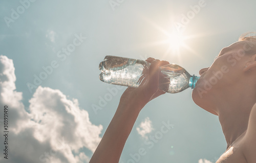 Female portrait drinking bottle water. 