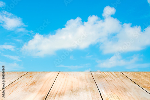Natural wooden table on the background is a fresh sky, used for editing trade shows. Business concept