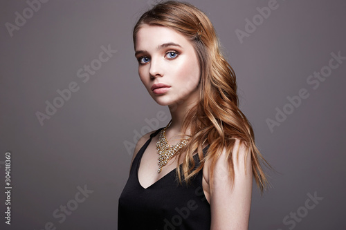 Beautiful sensual blond Girl in black dress and jewelry