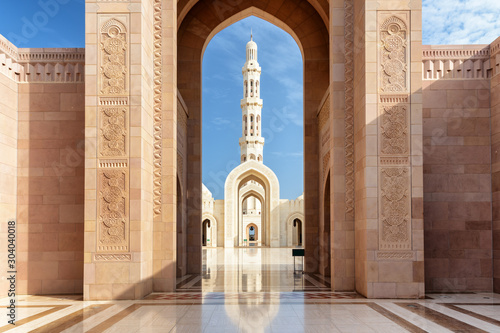 View of minaret through arches of Sultan Qaboos Grand Mosque