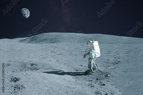 Astronaut is walking on the moon. With land on the horizon. Elements of this image were furnished by NASA.