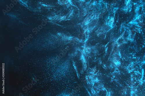 Abstract elegant, detailed blue glitter particles flow with shallow depth of field underwater. Holiday magic shimmering underwater space luxury background. Festive sparkles and lights. de-focused.