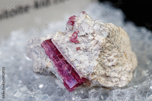 macro mineral stone red beryl on a black background