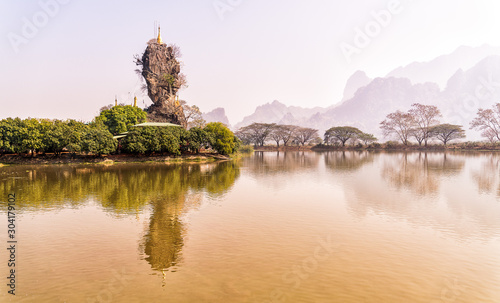 Buddhist burma temple in myanmar landscape with lake and trees