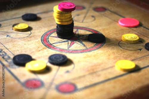 A game of carrom with pieces carrom man on the board carom - stacking.A game of carom set and ready to play