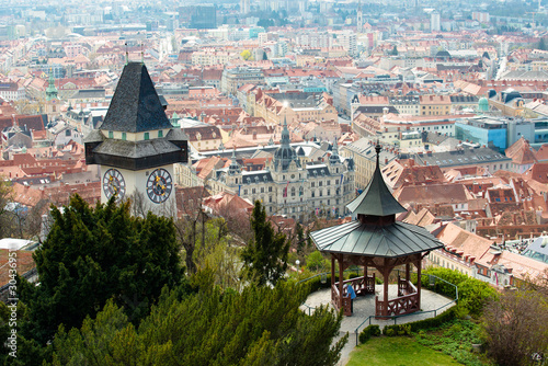 View at Graz City from Schlossberg hill, City rooftops, Mur river and city center, clock tower.