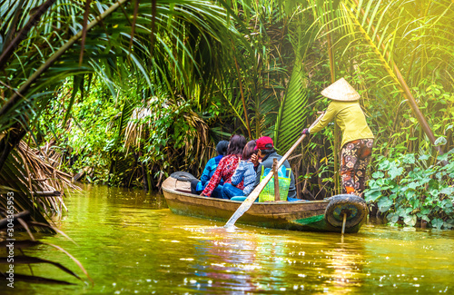 Tourist enjoying Mekong delta cruise with canoe on Vietnam