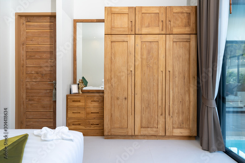 spacious and modern bedroom with wooden wardrobe