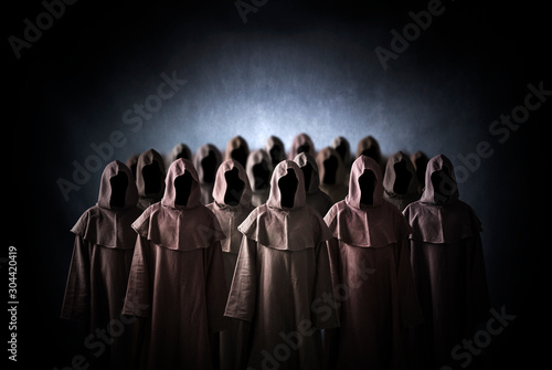 Group of scary figures in hooded cloaks