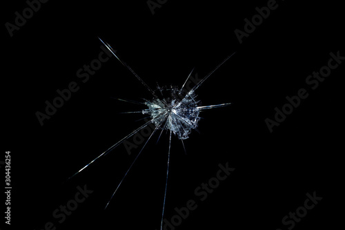 crack on the glass mirror in the form of abstraction on a black background
