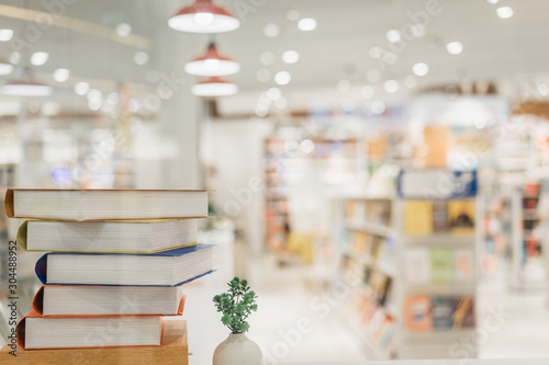 Book stack in the library room and blurred bookshelf background for business, education and back to school concept.