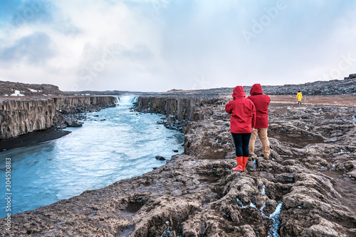 teo peoples ara watching on selfoss waterfall