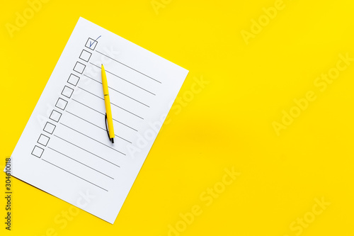 Empty check list ready to fill on yellow background top view space for text