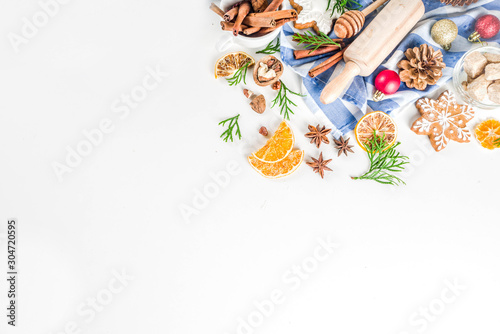 Christmas baking background. Christmas sweet cooking ingredients on white table. Ingredient for cooking christmas pastry, cookies and cakes, Flatlay on white table, top view with copy space