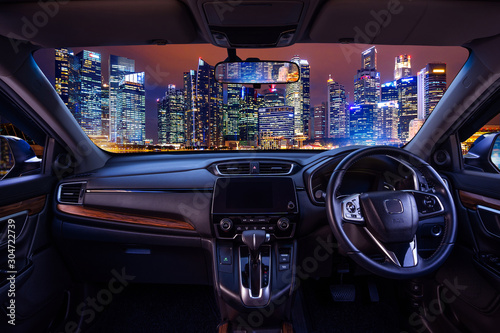 Looking through a car windshield with cityscape at night. Travel in car.