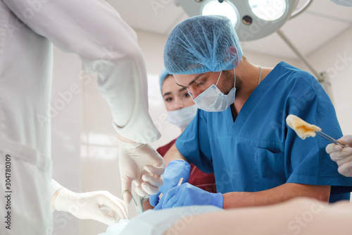 a group of surgeons doing operations in a hospital.