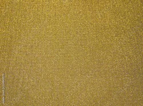 golden background, bright texture. fabric to pack up the Christmas gifts.