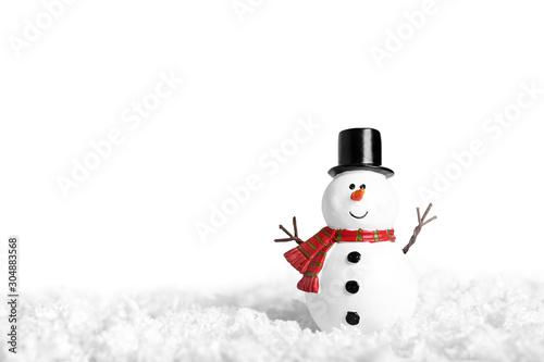 Toy of snowman on snow over white background