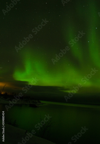 green northern lights aurora borealis in night sky