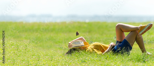 Woman relax and sleep chill in the meadow outdoor near sea beach. Lifestyle and Vacations Concept