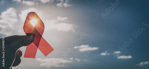 Red ribbon symbol of AIDS and HIV disease.