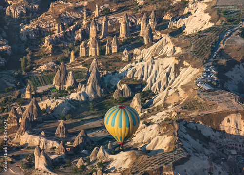 View from above to colorful hot air balloons flying over Love valley at early morning. Turkey, Cappadocia.
