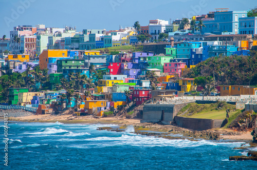 Colorful houses line the hill side overlooking the beach in San Juan, Puerto Rico.