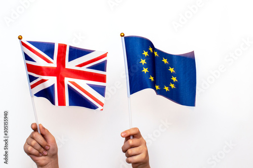 Flags of great Britain and the European Union hold hands on a white background.