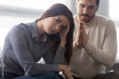 Young husband beg offended wife for forgiveness