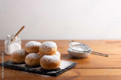 Carnival italian deep fried fritters with sugar icing,Homemade deep fried sweet fritters covered with sugar on a white background