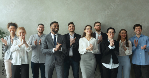 Group of business people clapping hands to congratulate boss