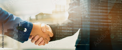 Close up of a business people with a handshake Agreements to do business together show trust and confidence in the investment in real estate. copy space of banner