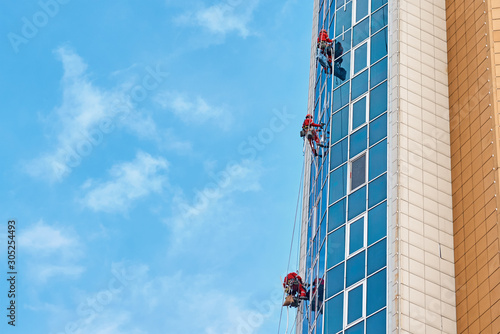 Group of industrial climber work on a modern building outdoor